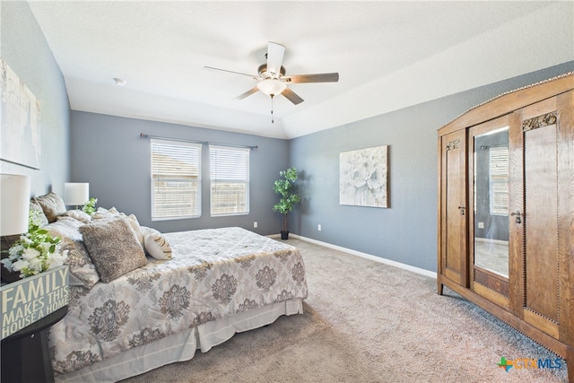 carpeted bedroom featuring ceiling fan and baseboards