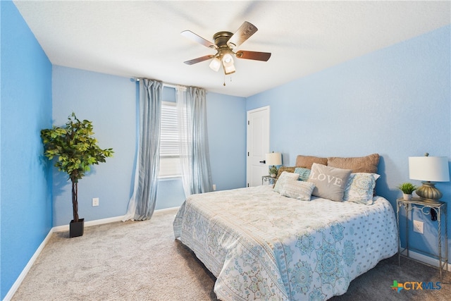carpeted bedroom featuring ceiling fan and baseboards