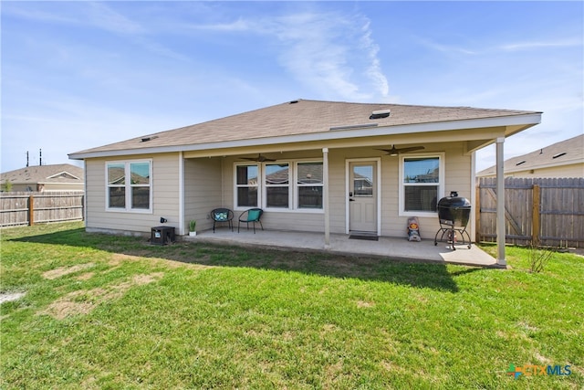 rear view of house featuring a fenced backyard, a patio area, a ceiling fan, and a lawn
