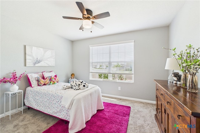 bedroom featuring ceiling fan, light carpet, and baseboards