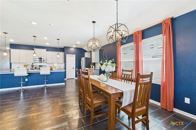 dining room with a chandelier, baseboards, and recessed lighting