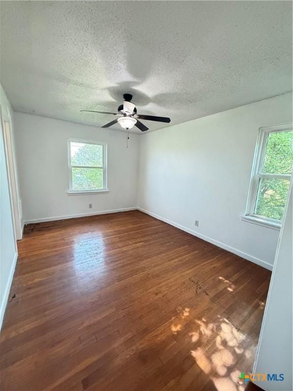 2310 Terrace Dr, Killeen, TX 76543 - spare room with baseboards, a ceiling fan, dark wood-style floors, and a textured ceiling
