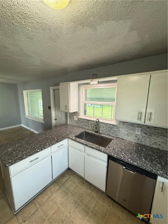 2310 Terrace Dr, Killeen, TX 76543 - kitchen with dishwasher, decorative backsplash, white cabinetry, and a sink