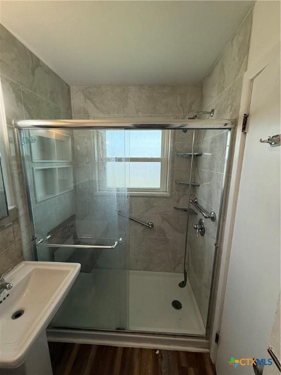 2310 Terrace Dr, Killeen, TX 76543 - full bathroom featuring wood finished floors, a stall shower, and a sink