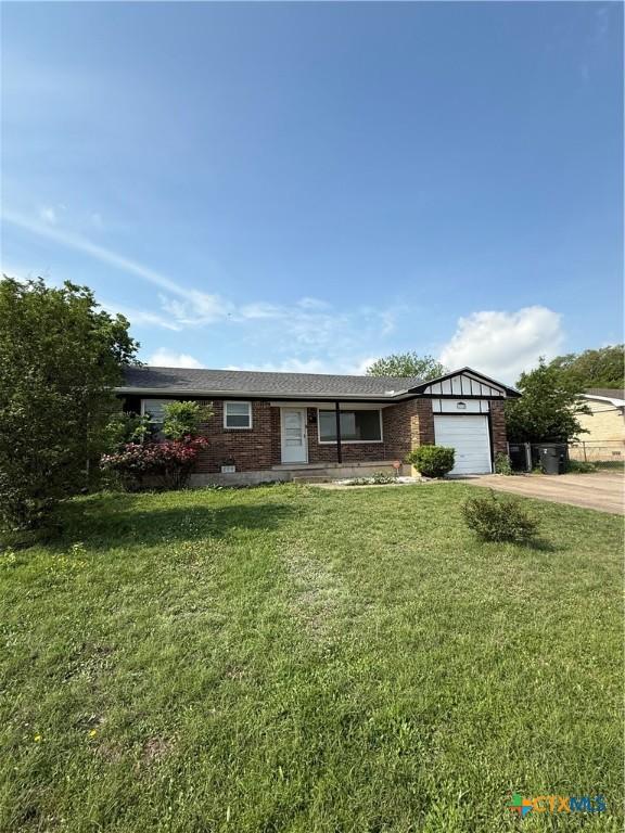 2310 Terrace Dr, Killeen, TX 76543 - ranch-style home with concrete driveway, an attached garage, brick siding, and a front lawn
