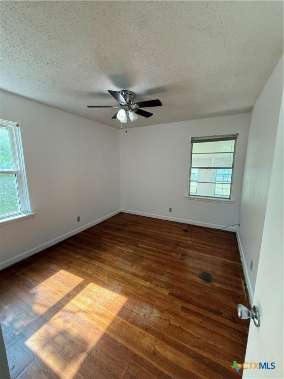 2310 Terrace Dr, Killeen, TX 76543 - spare room with wood finished floors, a textured ceiling, baseboards, and ceiling fan