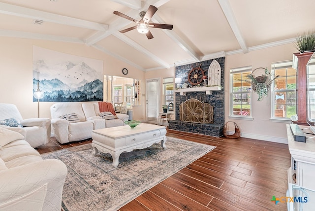 living room with a stone fireplace, lofted ceiling with beams, dark hardwood / wood-style flooring, and ceiling fan