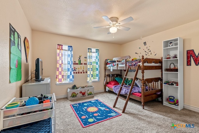 bedroom featuring a textured ceiling, carpet flooring, and ceiling fan