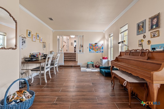 interior space with a textured ceiling, dark hardwood / wood-style flooring, and ornamental molding