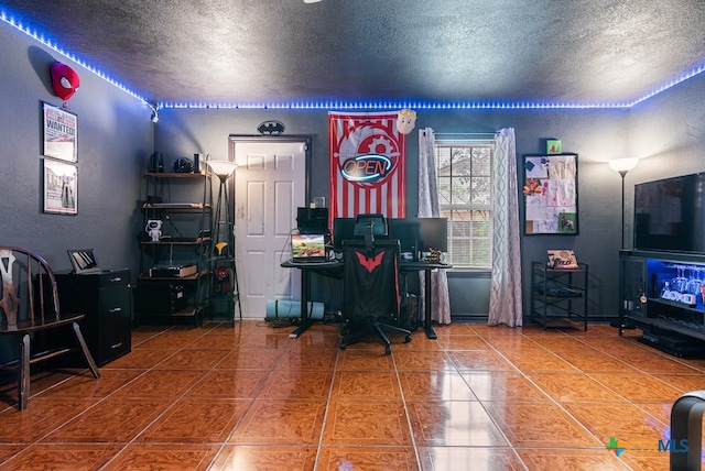 tiled home office featuring a textured ceiling