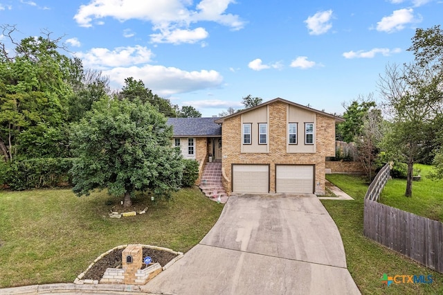 split level home with a garage and a front yard