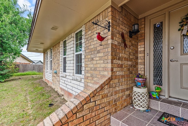 doorway to property featuring a yard