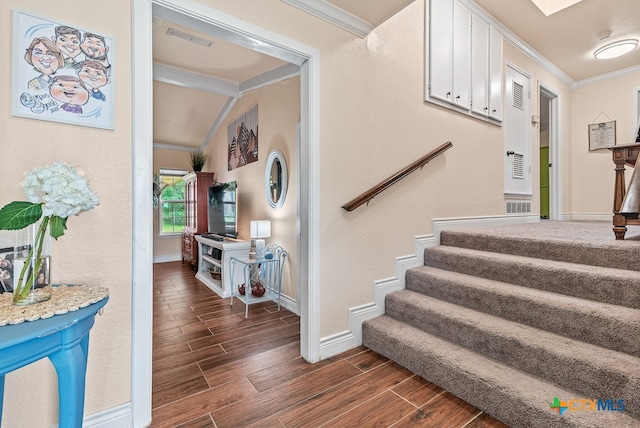 stairway with hardwood / wood-style flooring and ornamental molding