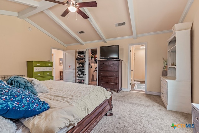 carpeted bedroom with lofted ceiling with beams, a closet, a spacious closet, connected bathroom, and ceiling fan