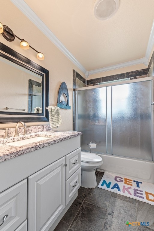 full bathroom with tile patterned floors, toilet, ornamental molding, shower / bath combination with glass door, and vanity