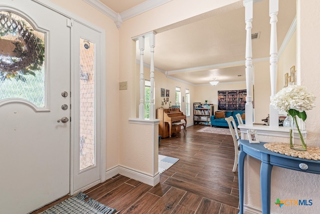 entrance foyer featuring dark hardwood / wood-style flooring, decorative columns, a healthy amount of sunlight, and crown molding