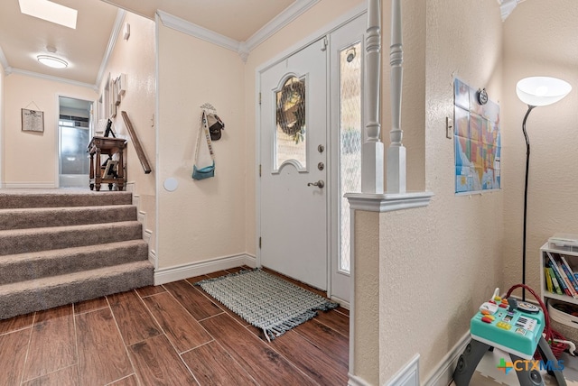 foyer entrance with a wealth of natural light, dark hardwood / wood-style floors, and crown molding