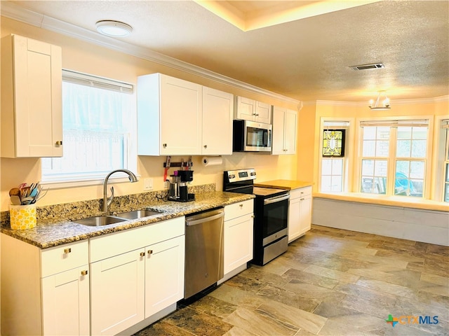 kitchen featuring white cabinets, a textured ceiling, and appliances with stainless steel finishes