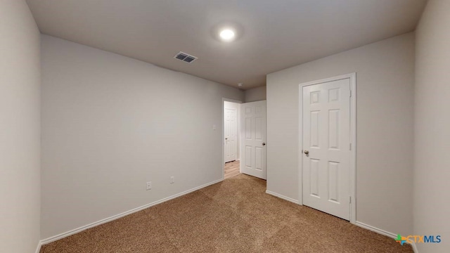 unfurnished bedroom featuring light carpet