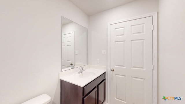 bathroom featuring toilet and vanity