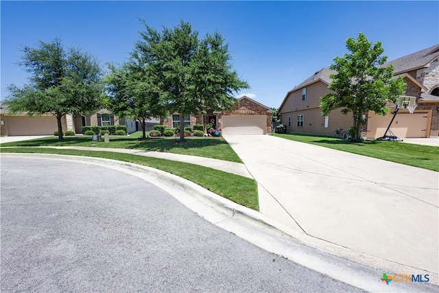 view of property hidden behind natural elements with a front yard and a garage