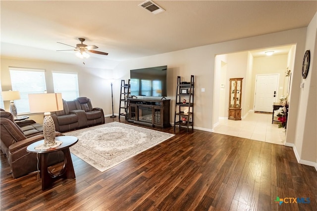 living room featuring a wealth of natural light, ceiling fan, and wood-type flooring