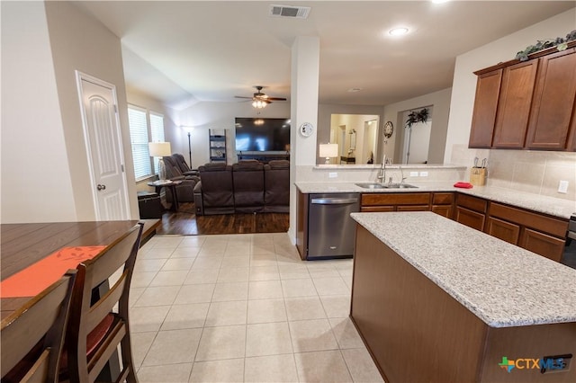 kitchen featuring dishwasher, sink, ceiling fan, light hardwood / wood-style floors, and kitchen peninsula