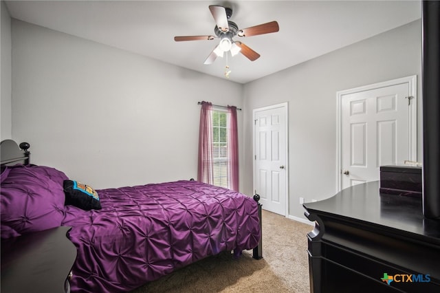 bedroom with ceiling fan and light colored carpet