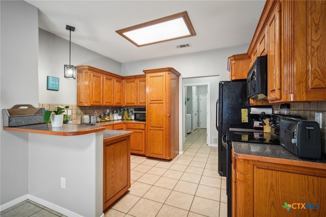 kitchen with kitchen peninsula, black appliances, light tile patterned flooring, and backsplash