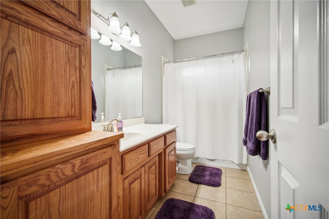 bathroom featuring toilet, vanity, and tile patterned floors