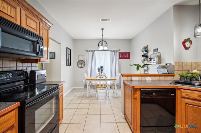 kitchen featuring black appliances, a notable chandelier, light tile patterned floors, pendant lighting, and decorative backsplash