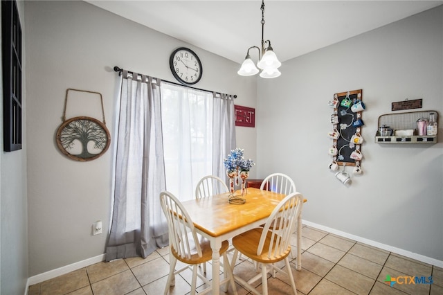 tiled dining room featuring a notable chandelier