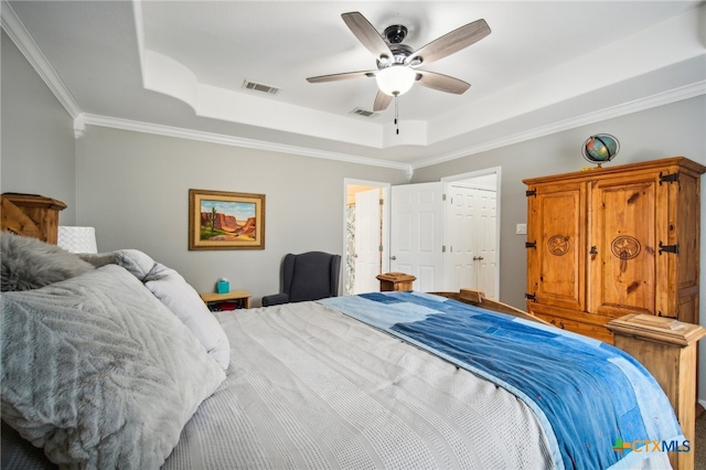 bedroom with ornamental molding, a closet, ceiling fan, and a raised ceiling