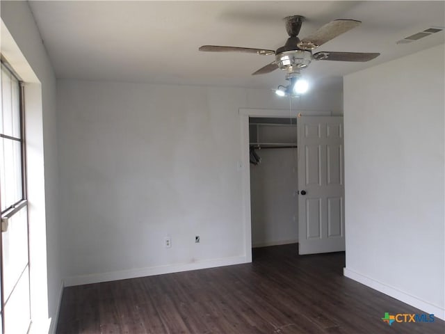 unfurnished bedroom featuring baseboards, visible vents, and wood finished floors