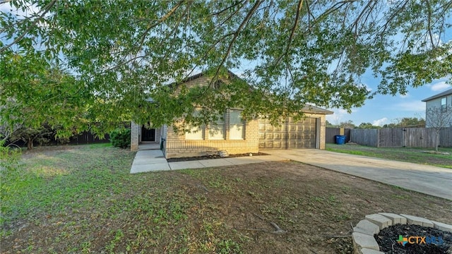 back of house with driveway, brick siding, and an attached garage