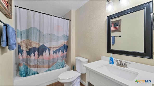 full bath featuring a textured wall, toilet, vanity, and shower / bath combo with shower curtain
