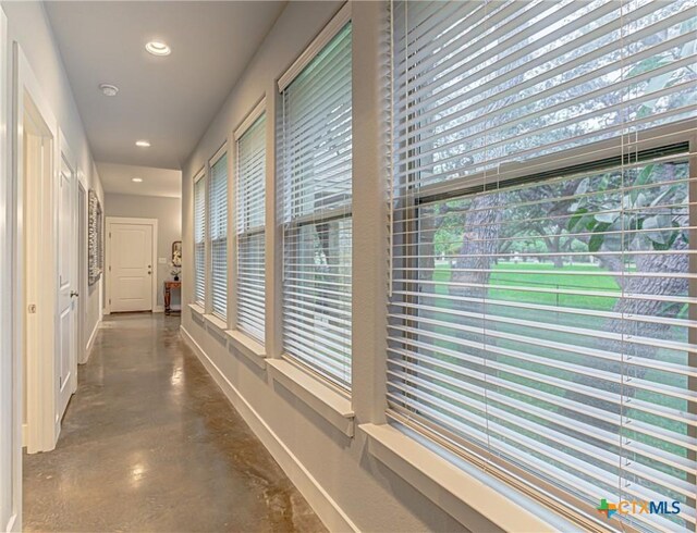 1002 Merry Ln, Kingsland, TX 78639 - hall featuring finished concrete flooring, plenty of natural light, and recessed lighting