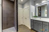 1002 Merry Ln, Kingsland, TX 78639 - bathroom with double vanity and a tile shower