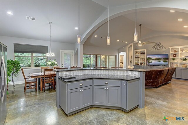 1002 Merry Ln, Kingsland, TX 78639 - kitchen with gray cabinetry, lofted ceiling, arched walkways, open floor plan, and ceiling fan