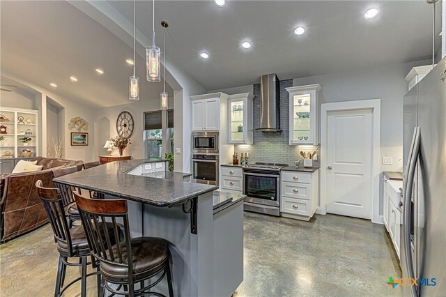 1002 Merry Ln, Kingsland, TX 78639 - kitchen with appliances with stainless steel finishes, wall chimney exhaust hood, finished concrete floors, a kitchen breakfast bar, and recessed lighting