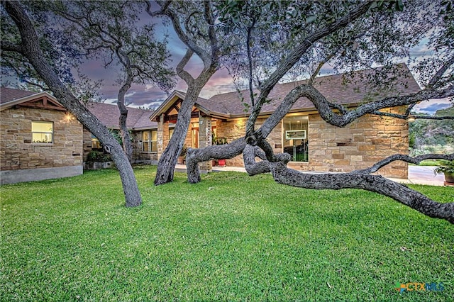 1002 Merry Ln, Kingsland, TX 78639 - view of front of home featuring stone siding, a front lawn, and roof with shingles