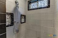 1002 Merry Ln, Kingsland, TX 78639 - bathroom featuring tiled shower