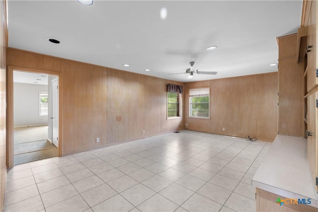 701 Live Oak St, Gatesville, TX 76528 - unfurnished room with wood walls, ceiling fan, recessed lighting, and light tile patterned flooring