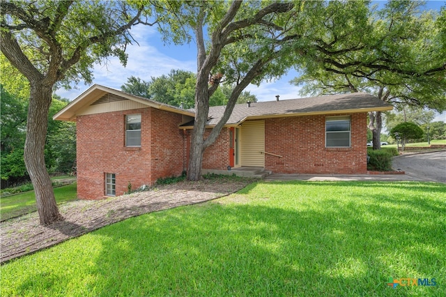 single story home featuring a front lawn