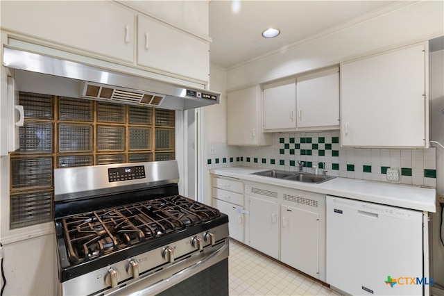 kitchen with white dishwasher, white cabinets, sink, stainless steel gas stove, and range hood