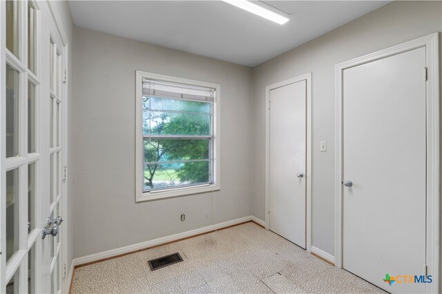 unfurnished bedroom featuring light colored carpet