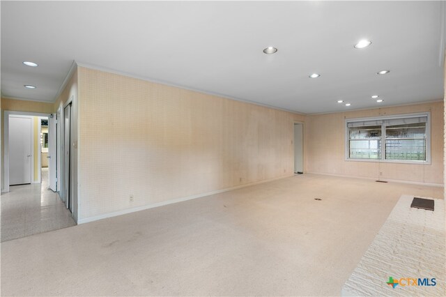 carpeted empty room featuring ornamental molding