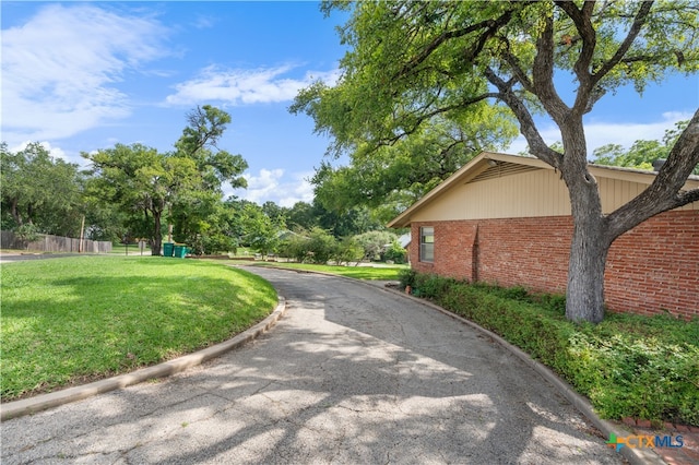 view of home's community with a yard