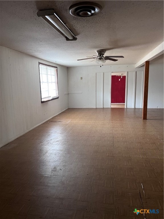 spare room featuring a textured ceiling and ceiling fan