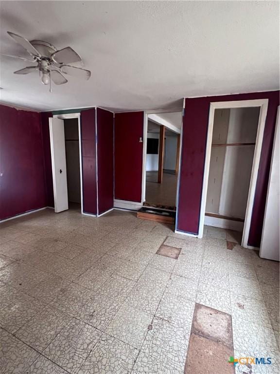 728 W Franklin St, Goliad, TX 77963 - unfurnished bedroom featuring multiple closets, light flooring, and baseboards
